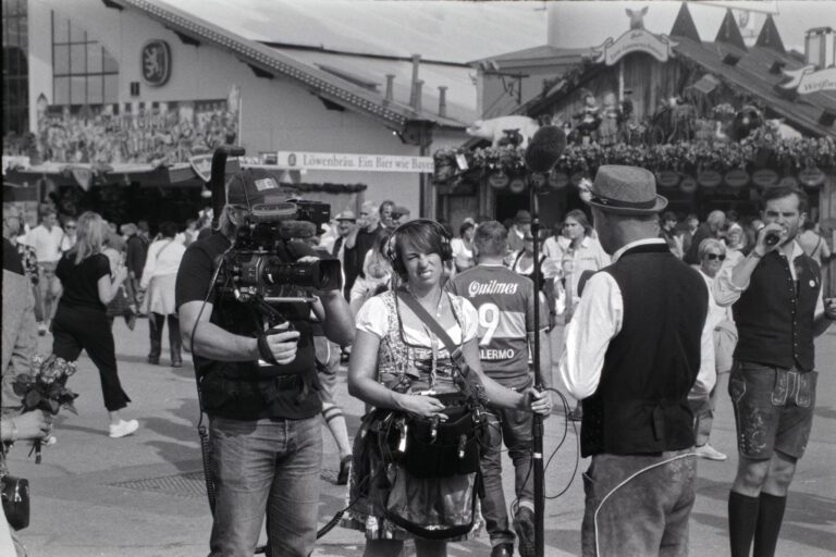 Black and white photo of Oktoberfest capturing people in traditional Bavarian attire.